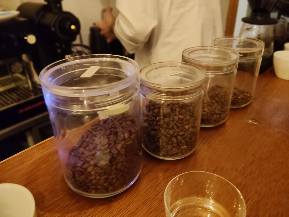 カウンターの上に並ぶ四つのガラス瓶。中の豆は色も焙煎の深さもそれぞれ違う。